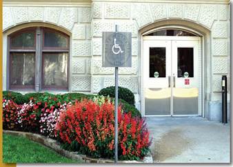 A sign with the wheelchair symbol on it indicates the accessible entrance seen in the background of this photo.