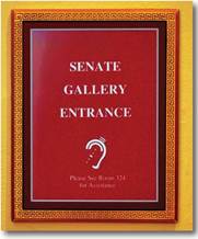 A sign reading, "Senate Gallery Entrance." A symbol of an ear indicating hearing impaired is followed by the instruction, "Please see room 324 for Assistance."